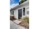 Guest house exterior with black door, landscaping and gravel driveway at 963 Highland Ave, Dunedin, FL 34698