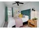 Cozy bedroom with a green headboard and soft textiles at 963 Highland Ave, Dunedin, FL 34698