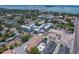 Aerial view showcasing a residential development with a mix of architectural styles near the water at 963 Highland Ave, Dunedin, FL 34698