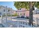 Charming pink house with white picket fence and gravel driveway at 963 Highland Ave, Dunedin, FL 34698