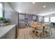 Modern kitchen with grey cabinets, stainless steel appliances, and tropical wallpaper at 963 Highland Ave, Dunedin, FL 34698