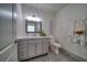 Modern bathroom with a gray vanity and marble countertop at 963 Highland Ave, Dunedin, FL 34698