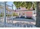 Charming pink house with white picket fence and gravel driveway at 963 Highland Ave, Dunedin, FL 34698