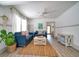 Bright living room featuring two blue sofas, a coffee table, and large windows at 963 Highland Ave, Dunedin, FL 34698