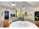 Small dining area with a round table and four brown leather chairs at 963 Highland Ave, Dunedin, FL 34698