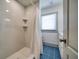 Simple bathroom with a shower and blue patterned floor at 963 Highland Ave, Dunedin, FL 34698