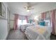 Bright bedroom with two twin beds, window seating, and soft pink curtains at 963 Highland Ave, Dunedin, FL 34698