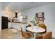 Modern kitchen with white shaker cabinets, a black refrigerator, and a breakfast table at 963 Highland Ave, Dunedin, FL 34698
