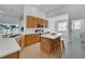 Modern kitchen with island, stainless steel appliances, and light wood cabinetry at 31415 Bridgegate Dr, Wesley Chapel, FL 33545