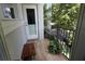 A charming balcony features a wooden bench and a potted plant, offering a cozy outdoor retreat at 1408 W Azeele St, Tampa, FL 33606