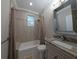 Neutral bathroom featuring a shower-tub combo, tiled walls, granite countertop and gray vanity at 1408 W Azeele St, Tampa, FL 33606