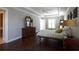 Cozy bedroom with hardwood floors, a ceiling fan, tray ceiling and natural light from windows at 1408 W Azeele St, Tampa, FL 33606