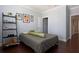 A cozy bedroom with a striped bedspread and wooden floors at 1408 W Azeele St, Tampa, FL 33606