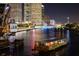 Nighttime cityscape view with a water taxi on the river and skyscrapers in the background at 1408 W Azeele St, Tampa, FL 33606