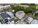 Aerial view showcasing a well-situated gray home with balconies and lush greenery, near a highway at 1408 W Azeele St, Tampa, FL 33606