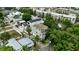 Aerial view showcasing a well-situated gray home with balconies and lush greenery, near other homes at 1408 W Azeele St, Tampa, FL 33606