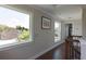 Hallway with hardwood floors, views from large windows and access to rooms and the staircase at 1408 W Azeele St, Tampa, FL 33606
