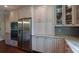 A modern kitchen featuring white cabinets, granite countertops, and stainless steel appliances at 1408 W Azeele St, Tampa, FL 33606