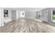 Spacious living area featuring light gray walls and wood-look vinyl flooring at 701 Madison Sw St, Ruskin, FL 33570