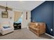 Charming Bedroom with airplane decor, crib, and comfortable armchair at 9098 Forge Breeze Loop, Wesley Chapel, FL 33545