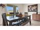 Dining room with dark wood table, bench seating, and view of backyard at 9098 Forge Breeze Loop, Wesley Chapel, FL 33545