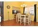 Charming dining area with a white table and chairs, and a pass-through to the kitchen at 3230 Jademoor Cir, Palm Harbor, FL 34685