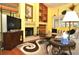 Bright living room with a fireplace, built-in shelving and hardwood floors at 3230 Jademoor Cir, Palm Harbor, FL 34685