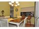 Bright dining room with a pass-through kitchen and chandelier at 3230 Jademoor Cir, Palm Harbor, FL 34685