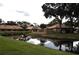 Community features a pond with lush landscaping at 3230 Jademoor Cir, Palm Harbor, FL 34685