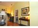 Open living space with a view into the main bedroom, hardwood floors and a console table at 3230 Jademoor Cir, Palm Harbor, FL 34685