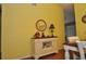 Dining room with a buffet table and a mirror, hardwood floors, and yellow walls at 3230 Jademoor Cir, Palm Harbor, FL 34685