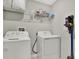 Laundry room with washer, dryer and shelving at 13573 Willow Bluestar Loop, Riverview, FL 33579