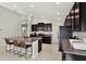 Kitchen with an island, granite countertops, and dark brown cabinets at 13573 Willow Bluestar Loop, Riverview, FL 33579