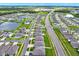 Aerial view of a residential community with houses, roads, and a lake at 13573 Willow Bluestar Loop, Riverview, FL 33579