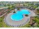 Community pool with plenty of lounge chairs and a covered patio area at 13573 Willow Bluestar Loop, Riverview, FL 33579
