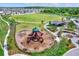Community playground with play structures and a large grassy area at 13573 Willow Bluestar Loop, Riverview, FL 33579