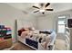 Bedroom with white sleigh bed and ceiling fan at 13573 Willow Bluestar Loop, Riverview, FL 33579