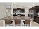 Spacious kitchen with dark cabinetry and granite island at 13573 Willow Bluestar Loop, Riverview, FL 33579