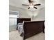 Bedroom with dark wood sleigh bed and ceiling fan at 13573 Willow Bluestar Loop, Riverview, FL 33579