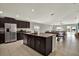 Open concept kitchen with stainless steel appliances and an island at 13573 Willow Bluestar Loop, Riverview, FL 33579