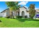 Single-story home with gray exterior, palm trees, and a landscaped lawn at 13573 Willow Bluestar Loop, Riverview, FL 33579