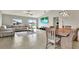 Spacious living room with L-shaped sofa and large screen TV at 13573 Willow Bluestar Loop, Riverview, FL 33579