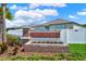 Sunstone Ridge community entrance sign with brick pillars and landscaping at 13573 Willow Bluestar Loop, Riverview, FL 33579