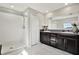 Bathroom with double vanity, large mirror and shower at 13573 Willow Bluestar Loop, Riverview, FL 33579