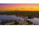 Aerial view of waterfront home and neighborhood at sunset with city skyline in background at 2030 Coffee Pot Ne Blvd, St Petersburg, FL 33704