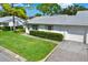 Exterior view of condo, showing garage and lawn at 3365 39Th S St # C-1, St Petersburg, FL 33711
