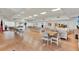 Spacious community room with tables, chairs, and a large screen TV at 3365 39Th S St # C-1, St Petersburg, FL 33711