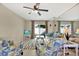 Living room with sofa, chairs, and access to a private patio at 3365 39Th S St # C-1, St Petersburg, FL 33711