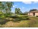 Spacious backyard with grassy area, trampoline, and patio at 4398 Candler Ave, Spring Hill, FL 34609