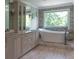 Modern bathroom with a freestanding soaking tub and large vanity at 1408 W Azeele St, Tampa, FL 33606